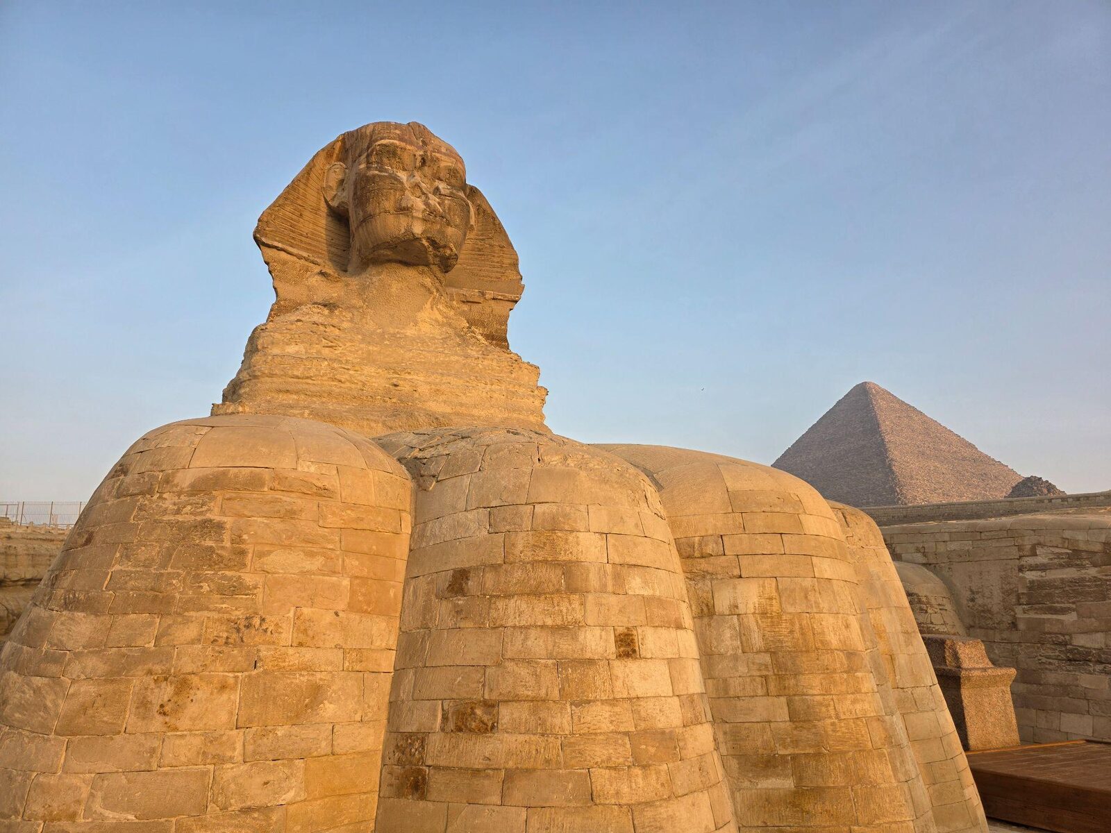 The Great Sphinx of Giza at golden hour with the pyramid of Khafre behind it