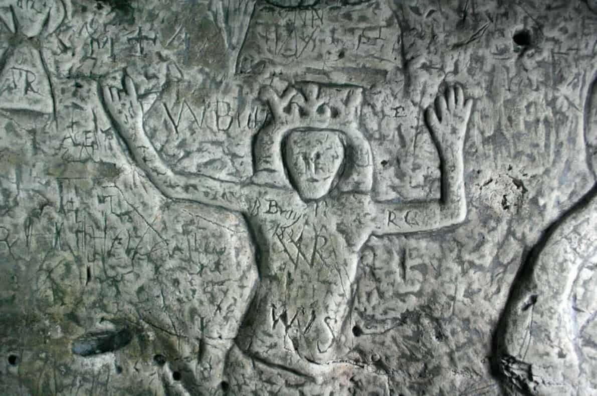 Medieval carving of a king on the wall of Royston Cave, England