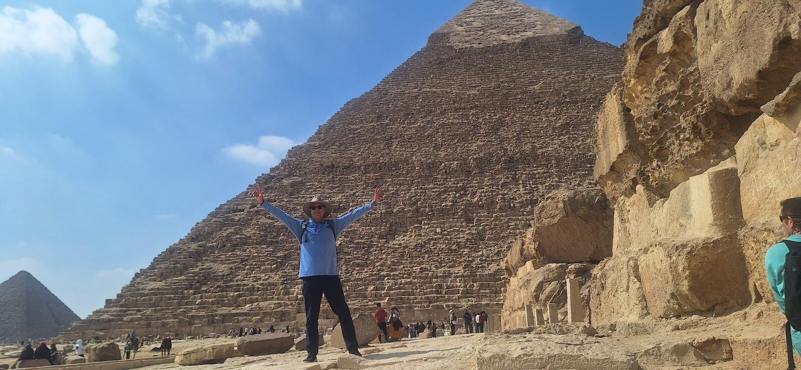 Traveler with arms raised in front of the Great Pyramid of Giza